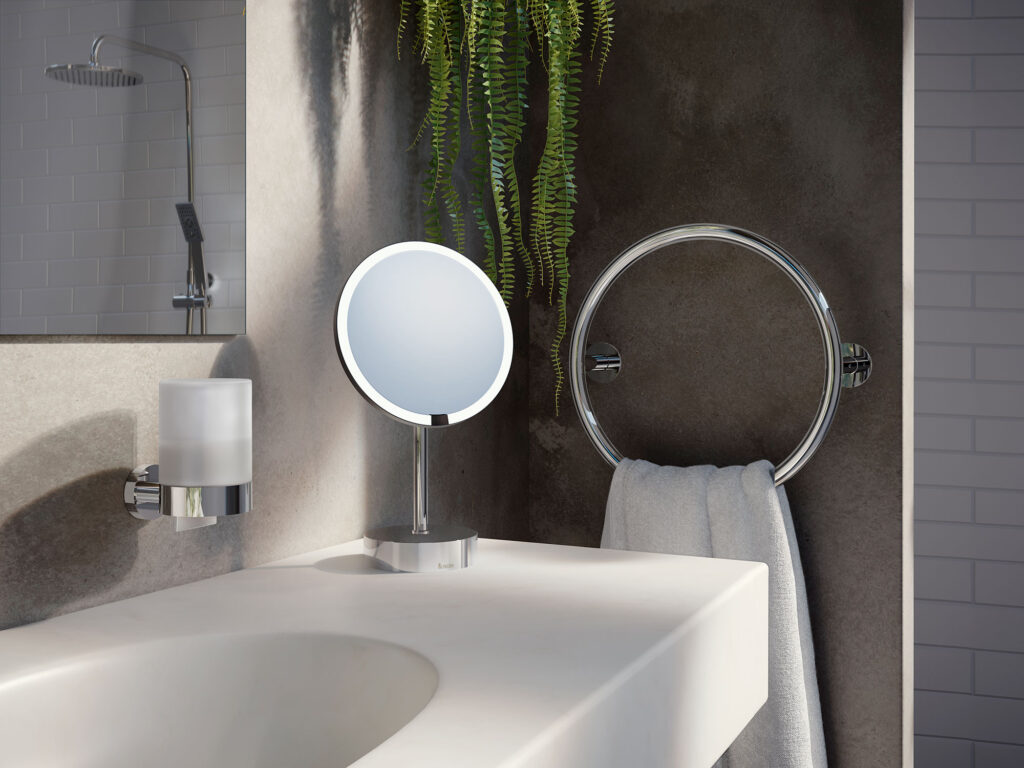 fristående spegel med led-belysning på kommod, handduksvärmare i cirkel uppsatt på grå vägg